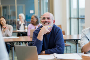 Diverse group of students have fun during their adult ed class at the local college.